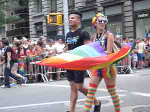 Boy marching with Rainbow Girl.