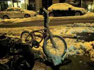 Frozen bike with missing seat; maybe it's warming up indoors?