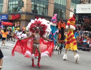 What you see is what you get: red headdress and stilt walkers.