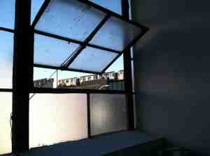 Seven train perched outside window.